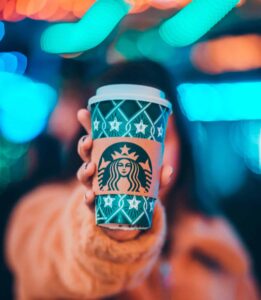 Woman holding Starbucks drink